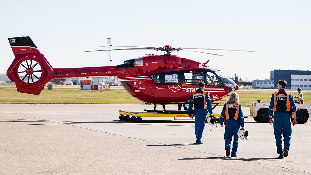 Emergency crew walking to helicopter