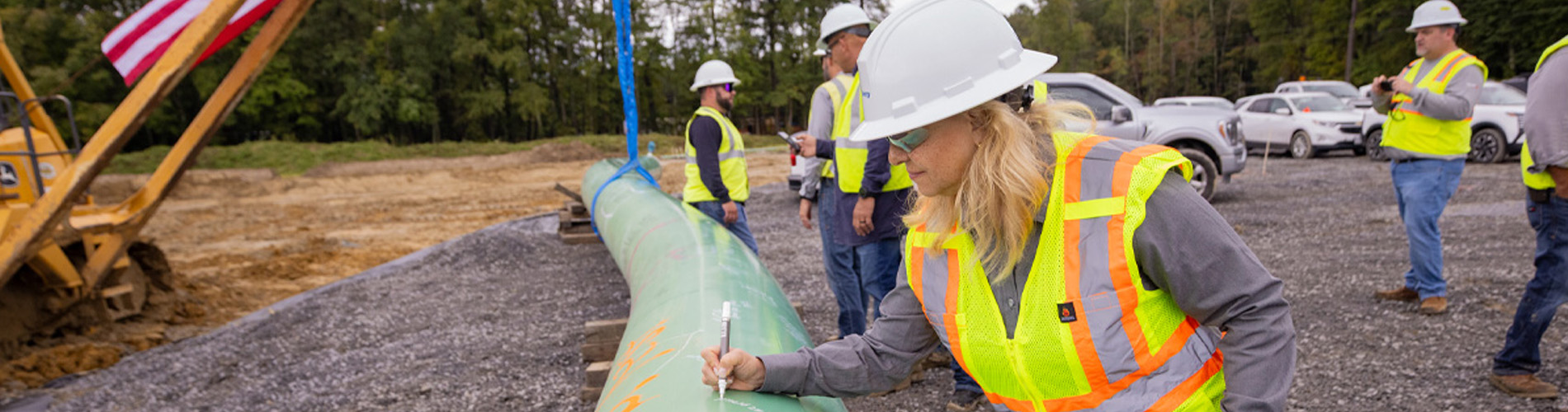 Worker signing a pipe