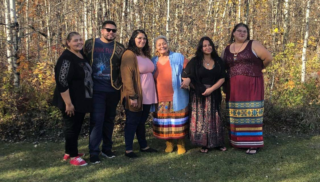Tyler with his mother (middle) and four sisters